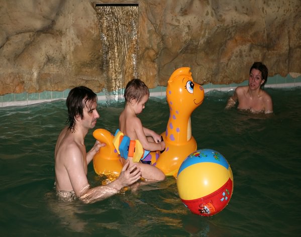 Nudists parents and young generation in a sauna